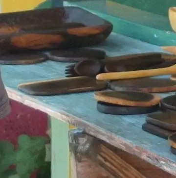 Carved wooden bowls, spoons and dishes on a blue table