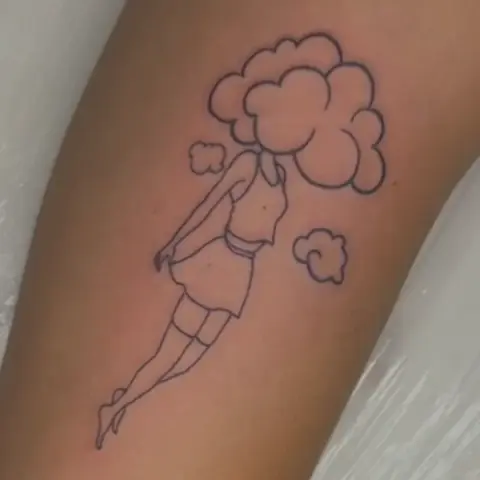 A line tattoo of a figure with a cloud for a head